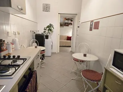 a kitchen with a stove and a table and chairs at Myomax Guesthouse Hospety Group in Rome