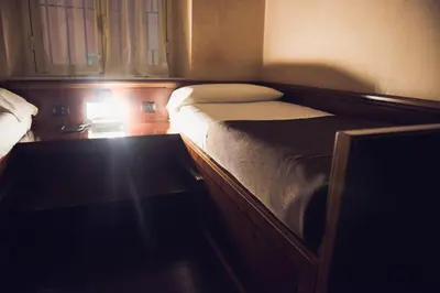 a small bedroom with a bed and a table at Hotel Robinson in Rome
