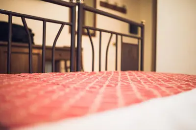 a close up of a bed with a red mattress at Hotel Robinson in Rome