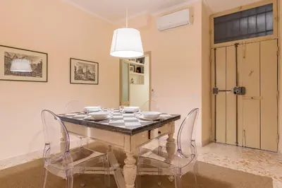 a dining room with a table and chairs at GuestHost - Campo De' Fiori Central Flat in Rome