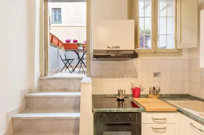 a kitchen with a stove top oven next to a window at GuestHost - Campo De' Fiori Central Flat in Rome