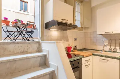 a kitchen with a sink and a stove top oven at GuestHost - Campo De' Fiori Central Flat in Rome