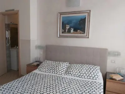 a bedroom with a bed and a picture on the wall at Bed & Breakfast Agli Horti Sallustiani in Rome