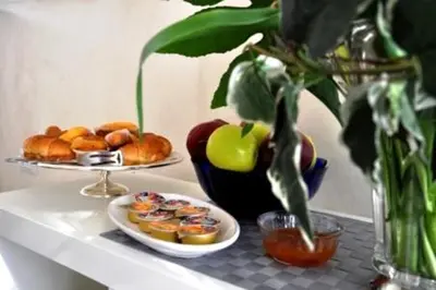 a table with two plates of food and a bowl of fruit at Bed & Breakfast Agli Horti Sallustiani in Rome