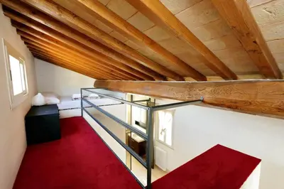a room with a red floor and a wooden ceiling at Pantheon Stylish Attic in Rome