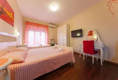 a bedroom with a bed and a desk and a mirror at AnnoDomini in Rome
