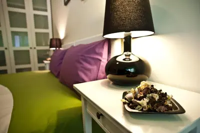 a table with a lamp and a plate of food on it at AnnoDomini in Rome
