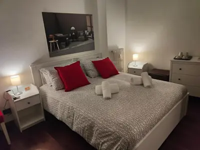 a bedroom with a bed with red and white pillows at AnnoDomini in Rome