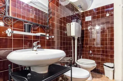 a bathroom with a sink and a toilet at Trastevere Apartments in Rome