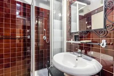 a bathroom with a sink and a shower at Trastevere Apartments in Rome