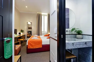 a hotel room with a bed and a bathroom at Colonna 32 in Rome
