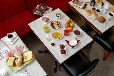 two tables with different types of food on them at Colonna 32 in Rome