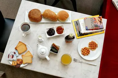 a table with plates of food and drinks on it at Colonna 32 in Rome