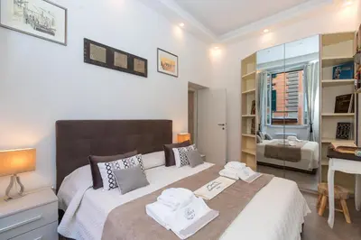 a bedroom with a bed with two towels on it at Boutique Domus Trastevere Bertani in Rome