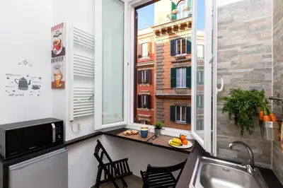 a small kitchen with a sink and a window at Boutique Domus Trastevere Bertani in Rome