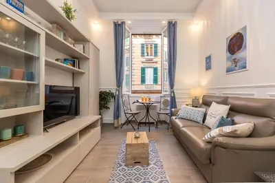 a living room with a couch and a tv at Boutique Domus Trastevere Bertani in Rome