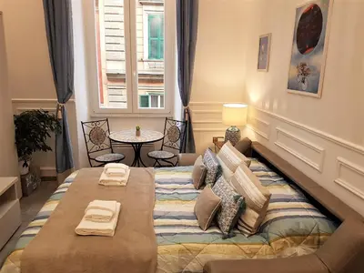 a bedroom with a large bed and a table at Boutique Domus Trastevere Bertani in Rome