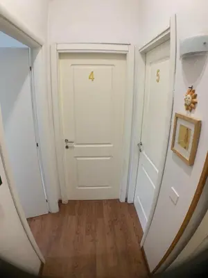 a hallway with a white door and a mirror at Vatican Garden House in Rome