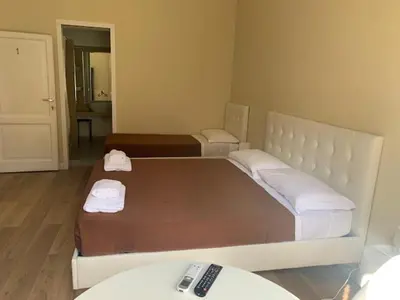 a bedroom with a large bed and a remote control at Vatican Garden House in Rome