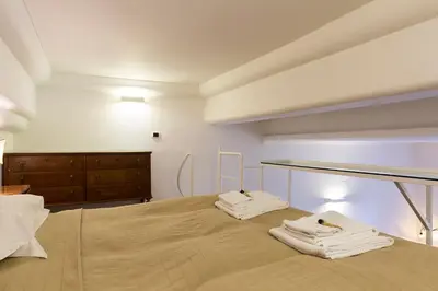 a bedroom with two white towels on a bed at Nice Apartment Navona Square in Rome