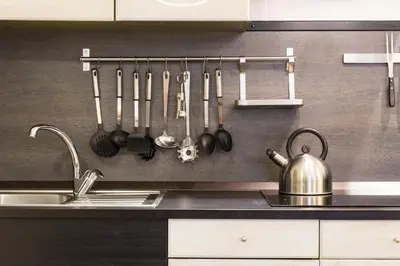 a kitchen with utensils hanging on a wall at Nice Apartment Navona Square in Rome