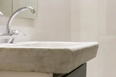 a concrete sink in a bathroom with a mirror at Nice Apartment Navona Square in Rome