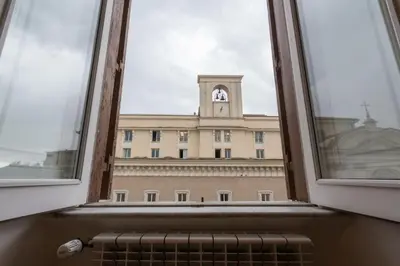 a window with a view of a building with a clock tower at Nice Apartment Navona Square in Rome