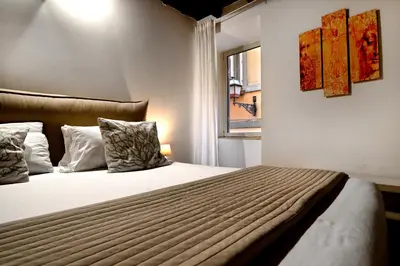 a bedroom with a bed and a window at Vicolo 22 - Residenze Romanae in Rome