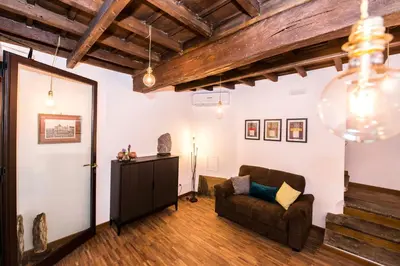 a living room with a couch and a table at Vicolo 22 - Residenze Romanae in Rome
