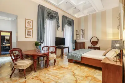 a bedroom with a bed and a table and chairs at Spagna Dream Suites in Rome