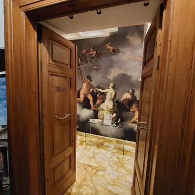 a door leading into a room with a painting on the wall at Spagna Dream Suites in Rome