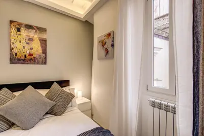 a bedroom with a bed and a window at Dimore Costaguti in Rome