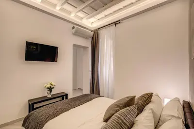 a bedroom with a bed and a couch at Dimore Costaguti in Rome