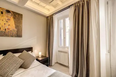 a bedroom with a bed and a window at Dimore Costaguti in Rome