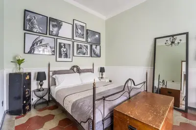 a bedroom with a bed and pictures on the wall at Trastevere Stylish in Rome