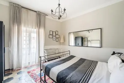 a bedroom with a bed and a mirror on the wall at Trastevere Stylish in Rome