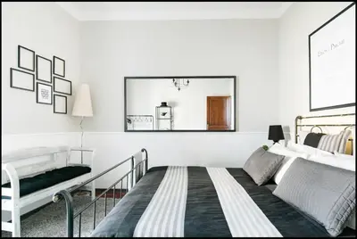 a white bedroom with a bed and a mirror at Trastevere Stylish in Rome