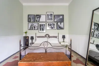 a bedroom with a bed and pictures on the wall at Trastevere Stylish in Rome