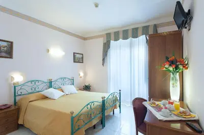 a bedroom with a bed and a table with food on it at Hotel Oriente in Rome