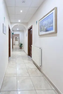 an empty hallway in a hospital with a painting on the wall at Hotel Oriente in Rome