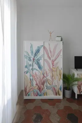 a cabinet in a room with a mural of flowers at Vicoloft Sales in Rome