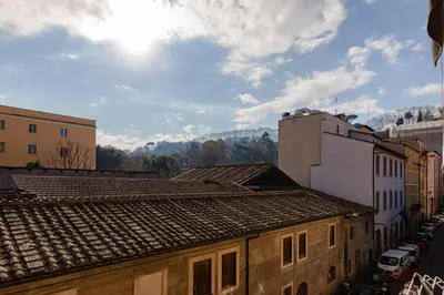 a view of roofs of buildings in a city at Vicoloft Sales in Rome