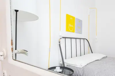 a mirror next to a bed in a room at Vicoloft Sales in Rome