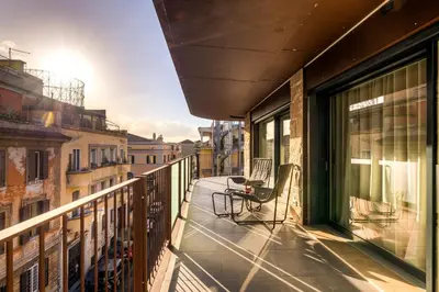 a balcony with a table and chairs on a building at Gasometer Urban Suites in Rome