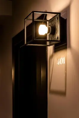 a light on the side of a black refrigerator at Chapter Roma in Rome