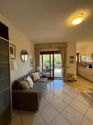 a living room with a couch and a kitchen at Residenza 