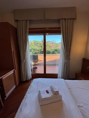 a bedroom with a bed with a view of a balcony at Residenza 