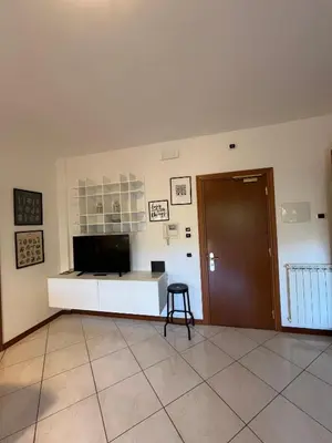 a room with a desk and a door and a stool at Residenza 