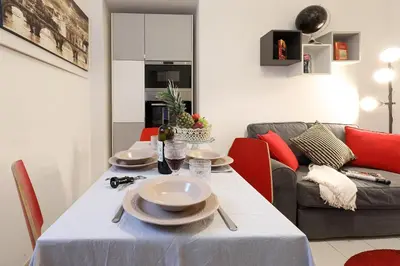 a dining room with a table and a couch at Grand Tour Rome Apartment - Liberty Collection in Rome