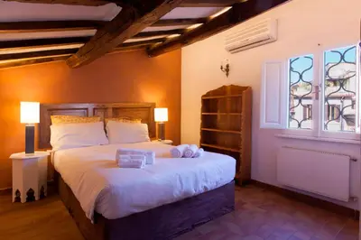 a bedroom with a bed with white sheets and a window at Home D'elite Navona in Rome